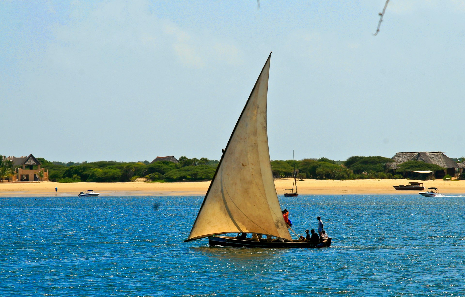 a sailboat with two people on it in the water